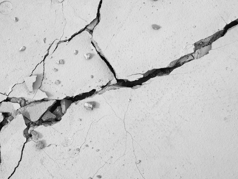 Cracked slab illustrating failures in concrete wall systems due to stress and long-term deterioration.